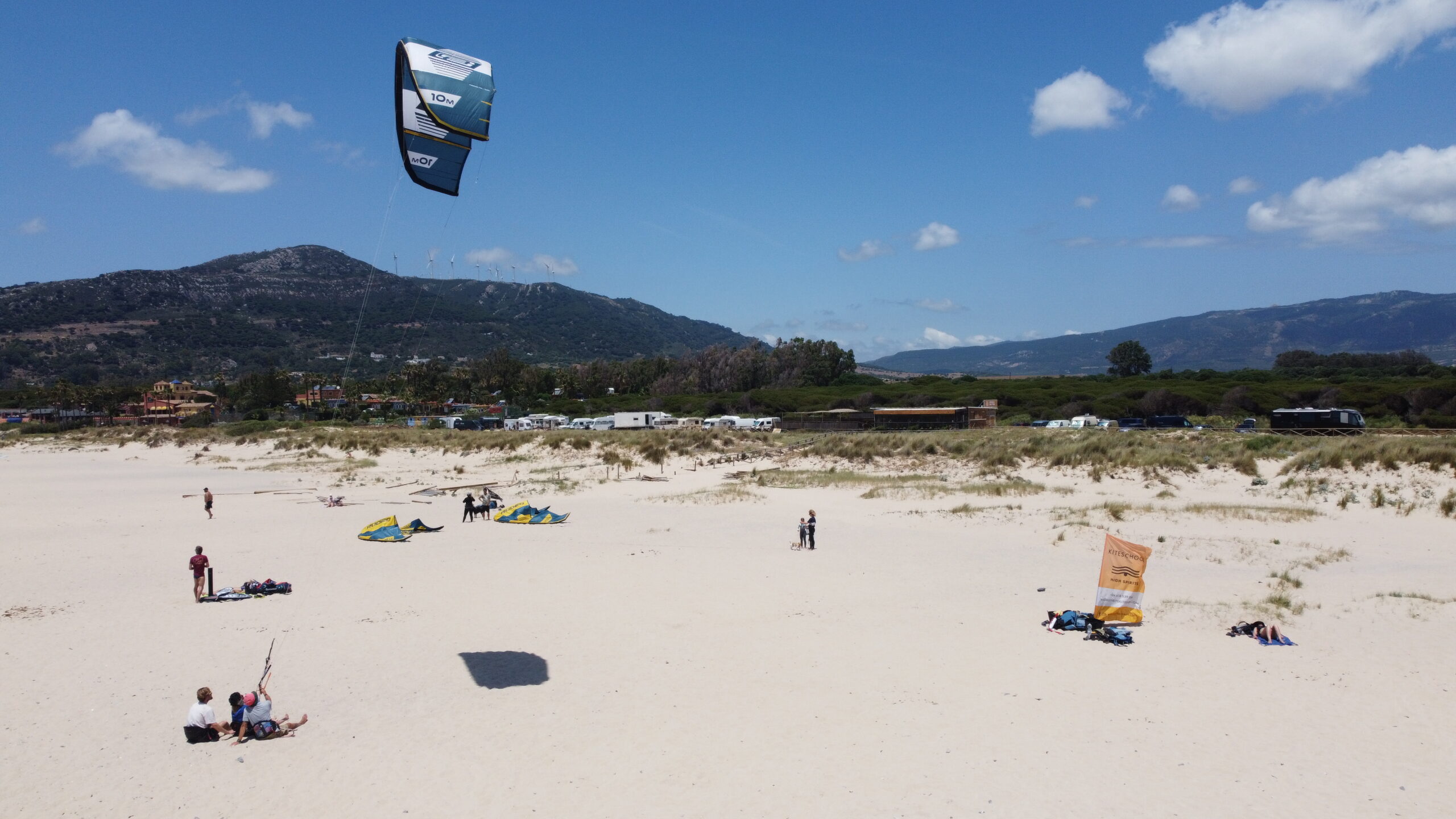 Kitesurf-Lehrer schult Schüler im Sitzen mit kurzen Leinen – sichere Lernmethode.