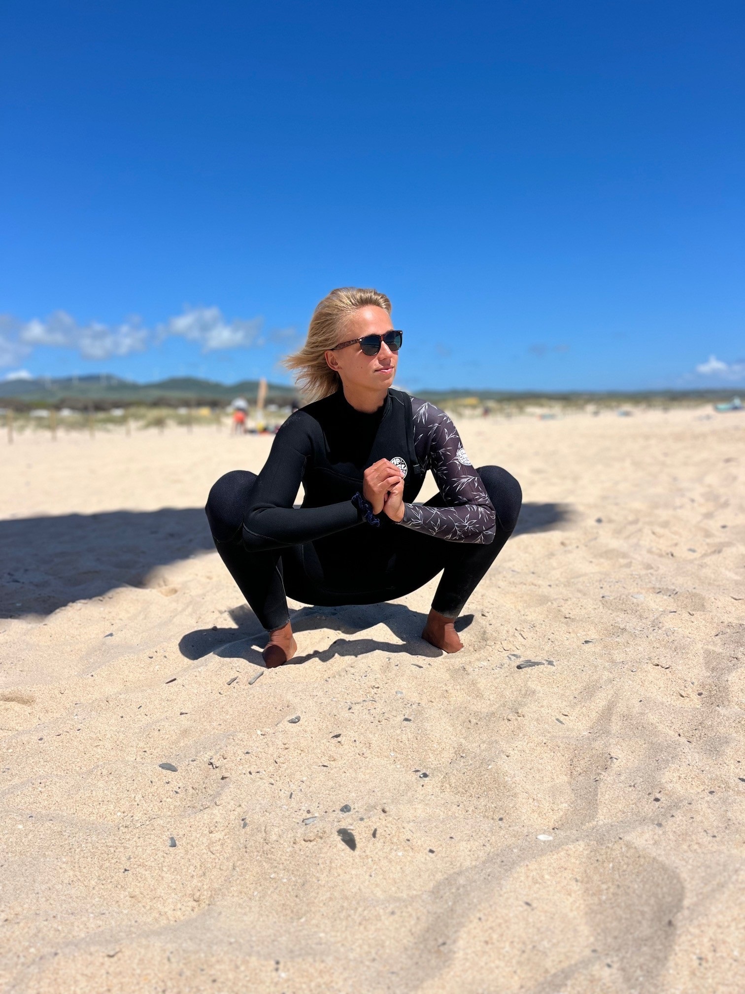 Deep squat hold with shoulder stretch to improve mobility, flexibility and body control for kitesurfing